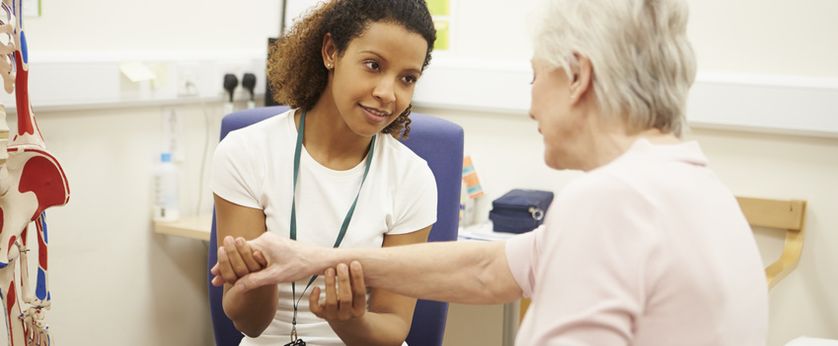 Physical therapist working on patients wrist.