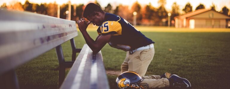 football player praying
