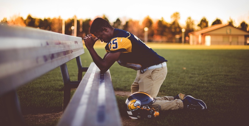 football player praying